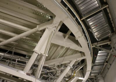 The underside of the circular Coude platform dominates the picture, with rectangular cabinets flanking the platform along the wall