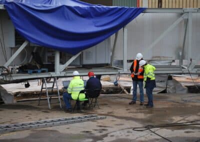 Workers from ATST, AEC-Idom, and MSI review the Enclosure's safety and control systems integration, mid-November 2013.