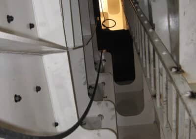 A view from inside the enclosure base ring looking upward along the maintenance access ladders of the arch girder interior, 29 July 2013.