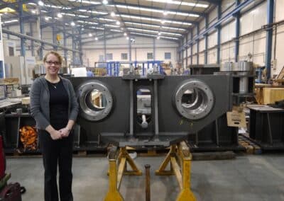 Enclosure Engineer Heather Marshall in front of an Azimuth Bogie Frame, December 2012.