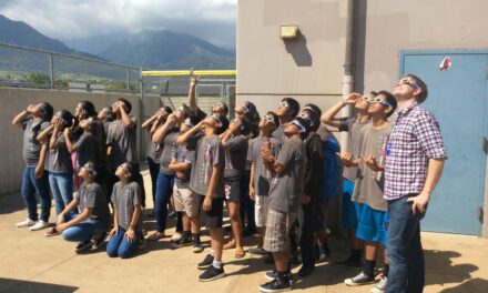 Students of Ms. Jessica Reed's Earth and Space Science class at Maui Waena Intermediate School view the sun through the NSO Maui Eclipse glasses, along with Dr. Tom Schad of the NSO. (Photo Credit: Jessica Reed)