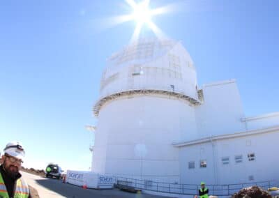 Inouye Solar Telescope sits below the brilliant sun. Because the sky is so clear, you can see the sun's rays.