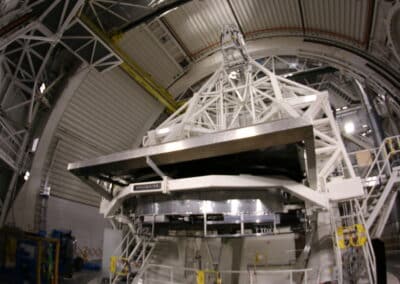 photo showcases the telescope mount assembly. it is a large white structure within the Inouye Solar Telescope