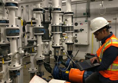 Manager inspects white pipes within the Inouye Solar Telescope