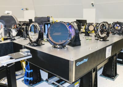 The Visible Broadband Imager (VBI)-blue channel’s feed optics are backdropped by the Facility Instrument Distribution Optics (FIDO). The VBI takes extremely high spatial resolution images of the solar surface and low atmosphere. The FIDO utilizes a suite of beamsplitters, windows, and mirrors to distribute light to the telescope’s science instruments.