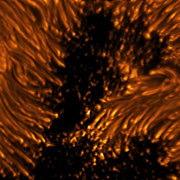 This image reveals the fine structures of a sunspot in the photosphere. Within the dark, central area of the sunspot’s umbra, small-scale bright dots, known as umbral dots, are seen. The elongated structures surrounding the umbra are visible as bright-headed strands known as penumbral filaments. Umbra: Dark, central region of a sunspot where the magnetic field is strongest. Penumbra: The brighter, surrounding region of a sunspot’s umbra characterized by bright filamentary structures. Image Title: Sunspot Umbral Dots and Penumbral Filaments in Detail PID: PID_1_27 Image Credit: NSF/AURA/NSO Image Processing: Friedrich Wöger(NSO), Catherine Fischer (NSO) Science Credit: Rolf Schlichenmaier at Leibniz-Institut für Sonnenphysik (KIS)